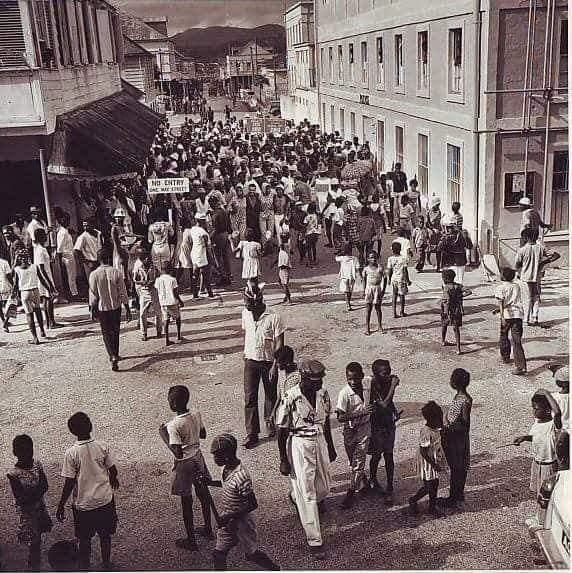 This photo shows Market Street looking south from Newgate Street, with the Police Station on the right and Murdoch’s store, on the left, during Carnival in 1964.